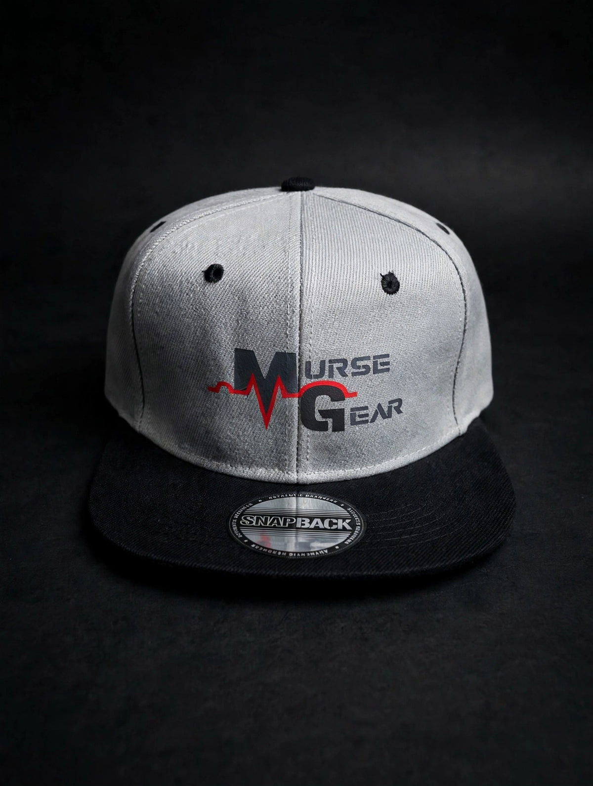 Gray and black Murse Gear flat bill snapback with MURSE GEAR logo - hero shot on dark charcoal background