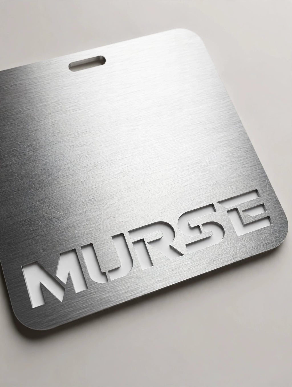 Murse Badge horizontal - close-up of engraved MURSE lettering and brushed texture