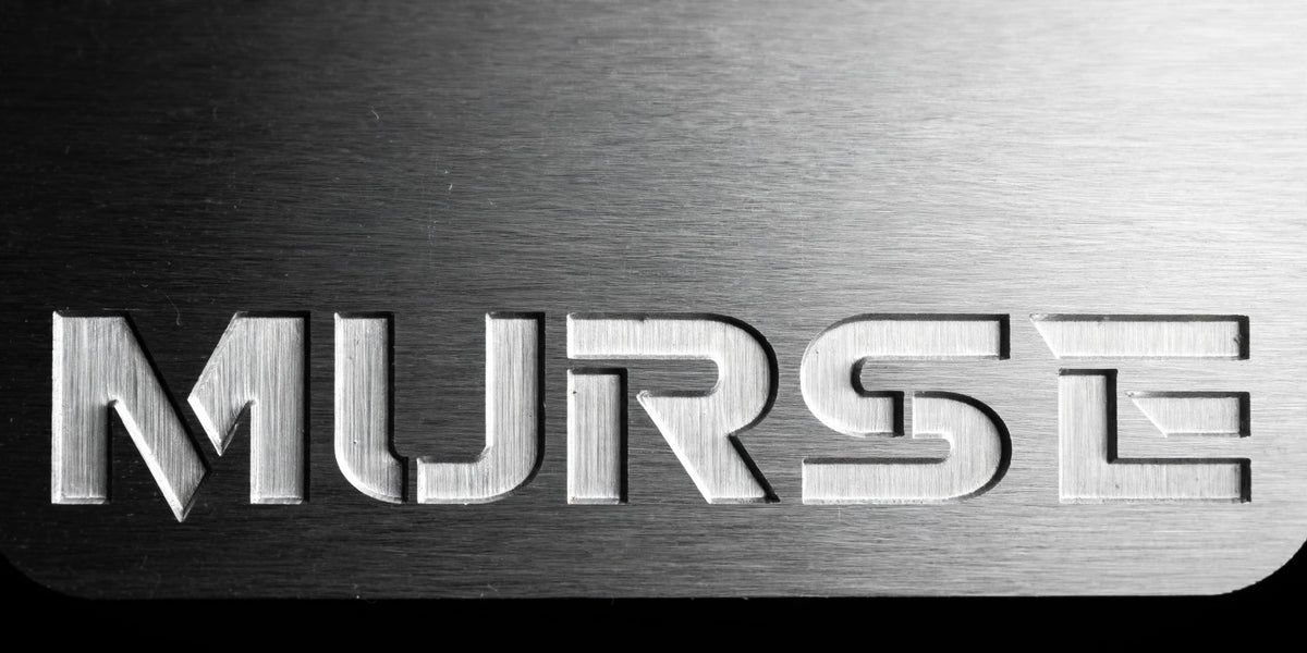 Murse Badge horizontal - extreme macro close-up of engraved MURSE lettering